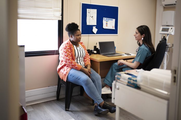 Patient talking with her doctor during an appointment in her office