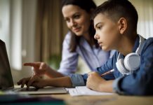 Mother helping teenager with homework