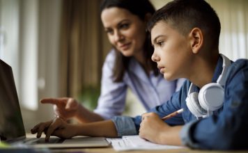 Mother helping teenager with homework