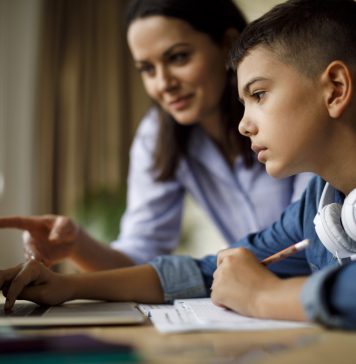 Mother helping teenager with homework