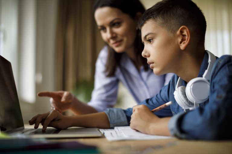 Mother helping teenager with homework