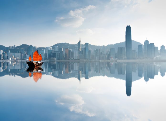 Junk boat crossing Hong Kong harbor