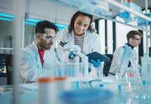 Modern Medical Research Laboratory: Portrait of Latin and Black Young Scientists Using Microscope, Digital Tablet, Doing Sample Analysis, Talking. Diverse Team of Specialists work in Advanced Lab