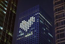 Heart shape in lights in downtown district office business buildings at night, digital composite. health promotion
