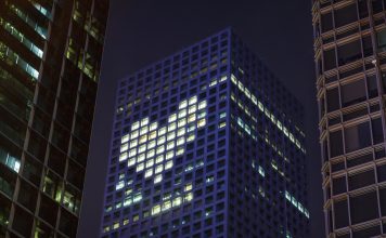 Heart shape in lights in downtown district office business buildings at night, digital composite. health promotion