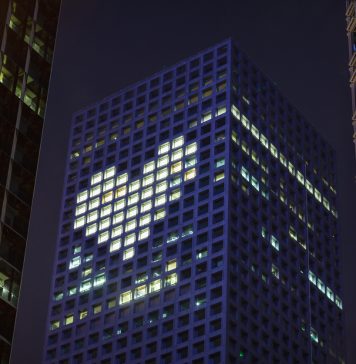 Heart shape in lights in downtown district office business buildings at night, digital composite. health promotion