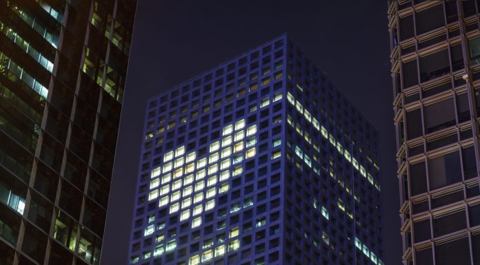 Heart shape in lights in downtown district office business buildings at night, digital composite. health promotion