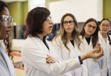 Girls in STEM, female science college students in classroom.