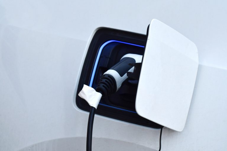 Close up or macro of a white electric car charging