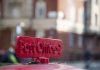 Old red cast iron sign to the Post Office in London, UK