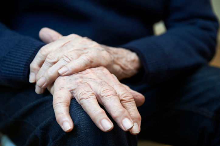 Close Up Of Senior Man Suffering With Parkinsons Diesease