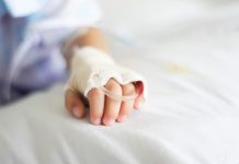 Saline intravenous (iv) drip in a Children's patient hand