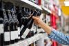 Woman is buying a bottle of wine at the supermarket background