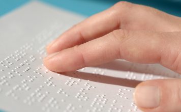 Blind woman reading text in braille