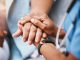 Empathy, trust and nurse holding hands with patient for help, consulting support and healthcare advice. Kindness, counseling and medical therapy in nursing home for hope, consultation and psychology.