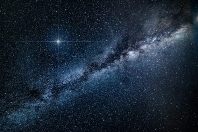 Amazing spike glowing lucky star and Milky Way Galaxy background - stock image