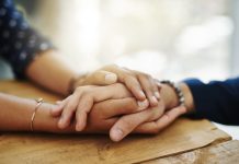 person holding women hand in comfort