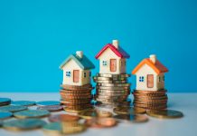 Miniature colorful house with stack coins