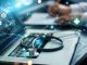 Healthcare business graph data and growth, Insurance Healthcare. Doctor analyzing medical of business report and medical examination with network connection on laptop screen.