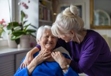 Woman hugging her elderly mother