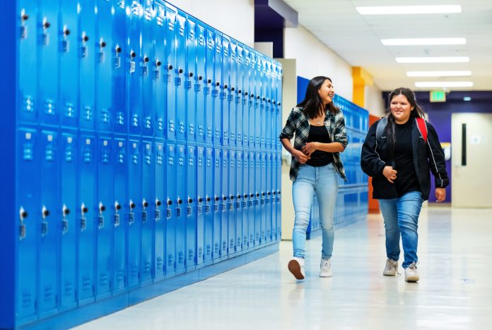 Students getting put of the classroom walking on a corridor
