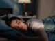 Young sad woman lying in bed late at night trying to sleep suffering insomnia. Girl in bed scared on nightmares looking worried and stressed. Sleeping disorder and insomnia concept