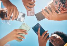 Phone circle, hands of people and low angle, communication or text. Blue sky, mobile and friends on social media, online group chat or wifi, sharing 5g data and surfing internet, web or online.