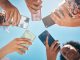 Phone circle, hands of people and low angle, communication or text. Blue sky, mobile and friends on social media, online group chat or wifi, sharing 5g data and surfing internet, web or online.