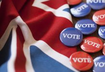 Red and blue voting badges with the union jack flag. The badges are circular with the word vote written in white capital letters.