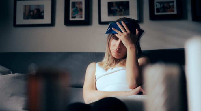 Unhappy person having a headache after physical injury at home