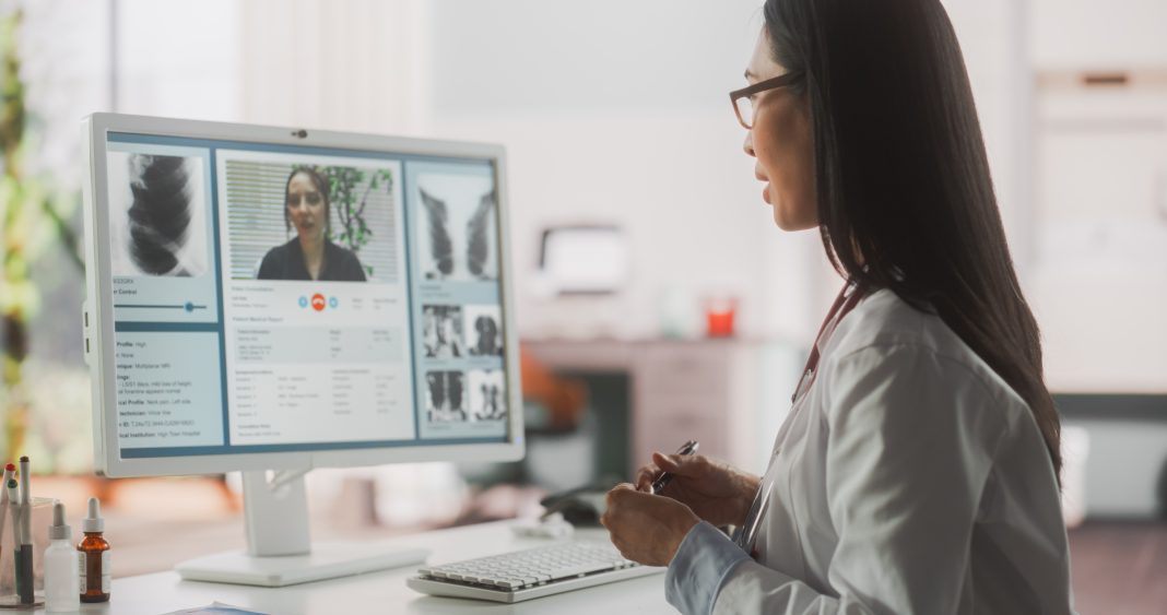 retired specialists, Hospital Medical Doctor Office: Portrait of Professional Female Physician Working on Desktop Computer, Talking to a Patient on a Internet Video Call Consultations, Writing Digital Prescriptions