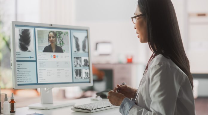 retired specialists, Hospital Medical Doctor Office: Portrait of Professional Female Physician Working on Desktop Computer, Talking to a Patient on a Internet Video Call Consultations, Writing Digital Prescriptions