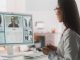 retired specialists, Hospital Medical Doctor Office: Portrait of Professional Female Physician Working on Desktop Computer, Talking to a Patient on a Internet Video Call Consultations, Writing Digital Prescriptions