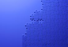 Overhead shot of blue jigsaw puzzle on blue background with copy space.