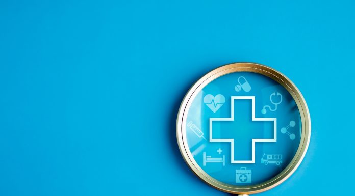 Healthcare service, hospital website online search, wellness plan and insurance concept. Health, care and medical element icon symbols in magnifying glass lens on blue background with copy space.