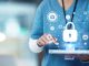 Medical cybersecurity, tablet and hands of doctor, surgeon or nurse with virtual hologram for database lock. Mockup hospital, life insurance and woman with digital archive biometric for info safety