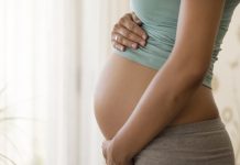 Pregnant woman embracing her belly