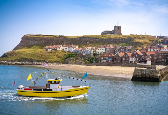 Whitby skyline and river Esk and boats UK in Scarborough Borough Council of England United