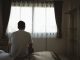 Silhouette depressed man sadly sitting on the bed in the bedroom. Sad asian men suffering depression insomnia awake and sit alone on the bed in bedroom. Depression health people concept.