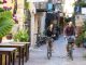 Couple explores old village streets on bicycles