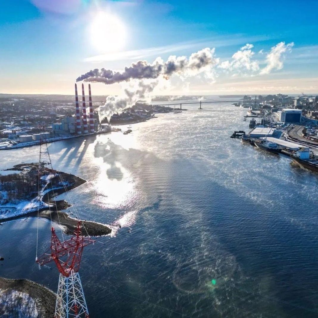 On the left is an aerial view of Halifax Harbour with a local power plant, as indicated by the three cooling towers. Credit: Noah James Media