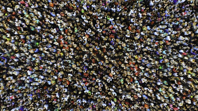 Big crowd of people. People gathered together in one place. Top view from drone.