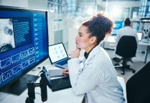 Computer, screen and scientist in laboratory with thinking, planning and analysis with medical research. Healthcare, woman doctor and brainstorm with digital for experiment, investigation and results