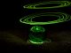 The ecological transition to clean energy. Green electricity. An energy reactor represented by a glass ball. Above it, green halos hover. Space for text.