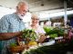 Mature couple shopping vegetables and fruits on the market. Healthy diet.