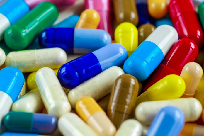 Drug prescription for treatment medication. Pharmaceutical medicament, cure in container for health. Pharmacy theme, capsule pills with medicine antibiotic in packages.