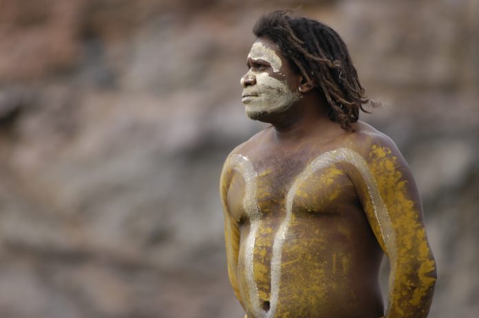 Cairns, Queensland, Australia - August 28th, 2005: An Aboriginal Man with body paint, with thoughtful stare in Cairns, Queensland in Australia on 28th August 2005