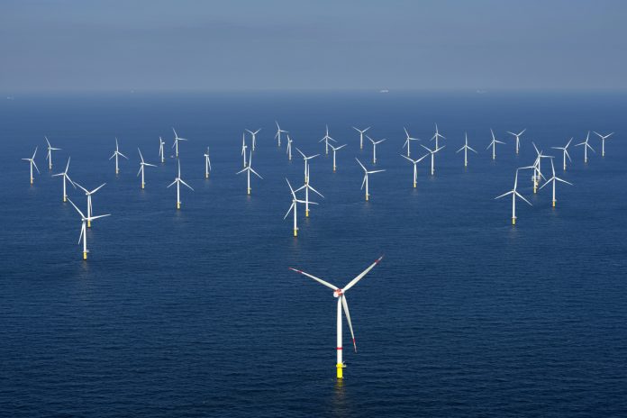 Alternative energy. Aerial view of offshore windmill park at sea.