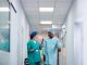 Female doctor communicating with African American senior man who is recovering after surgery in the hospital. NHS case studies
