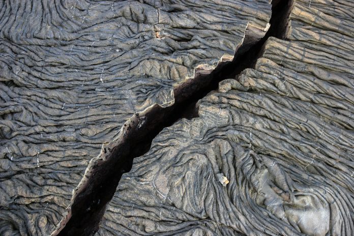 A relatively new flow of lava covers this island as there is no vegetation present at all, though the cracks have begun to show
